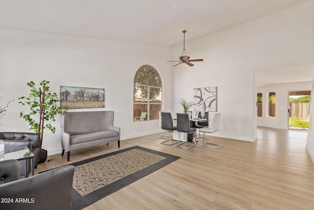 living room featuring light hardwood / wood-style floors and ceiling fan