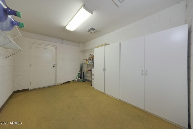 garage with visible vents and concrete block wall