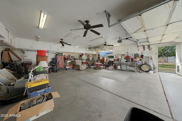 garage with a garage door opener and a ceiling fan