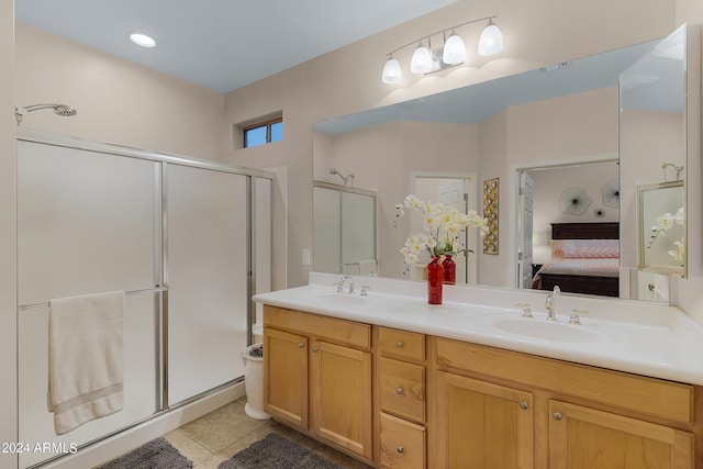 full bath with tile patterned floors, double vanity, a sink, and ensuite bathroom