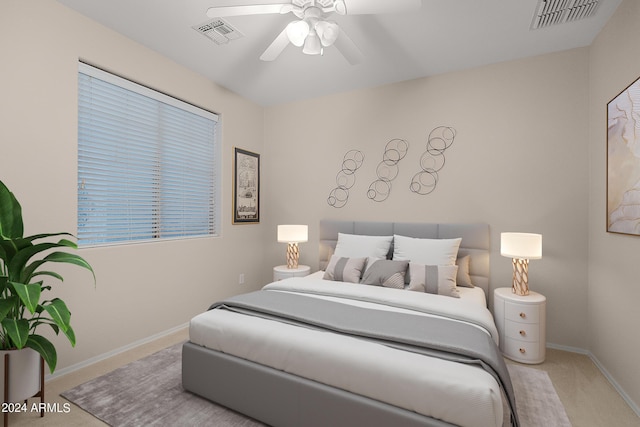 bedroom with a ceiling fan, baseboards, visible vents, and carpet flooring