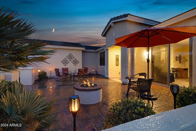 patio terrace at dusk with a fire pit