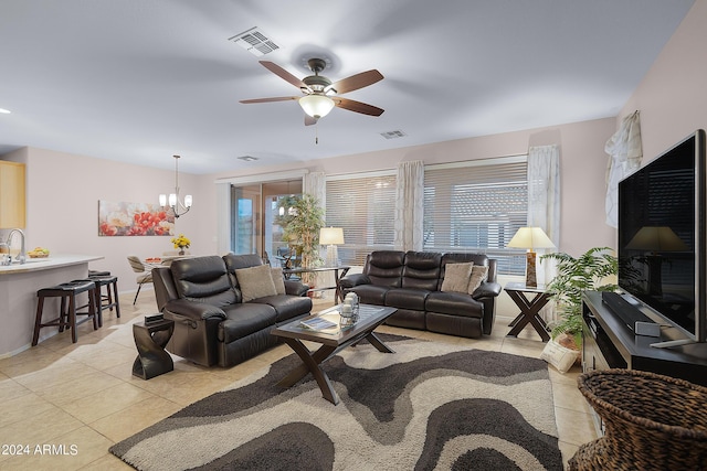 living area featuring light tile patterned floors, visible vents, and a wealth of natural light