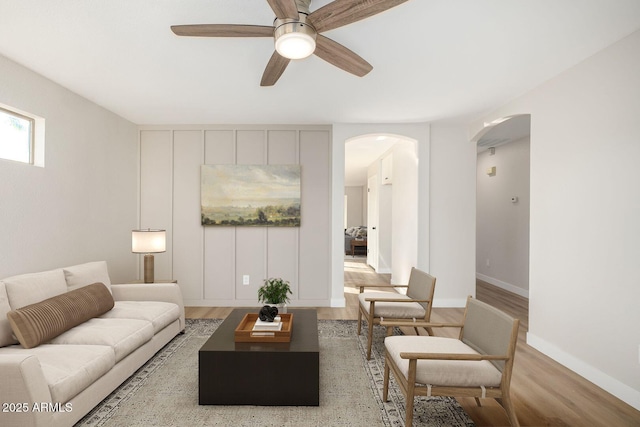 living room with light wood-type flooring and ceiling fan