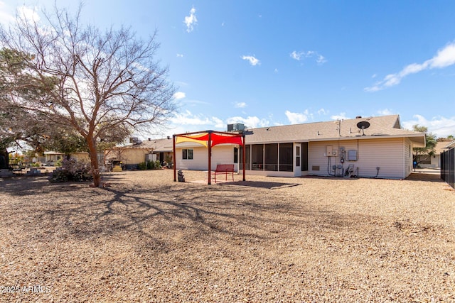 rear view of property with a patio area and a sunroom