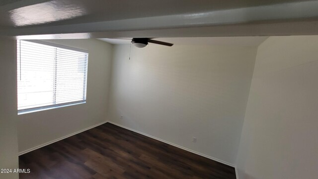 spare room featuring ceiling fan and dark hardwood / wood-style floors