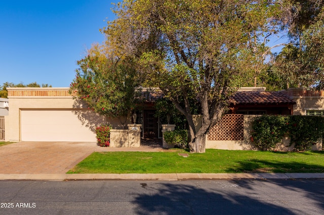 view of front of house featuring a garage and a front lawn