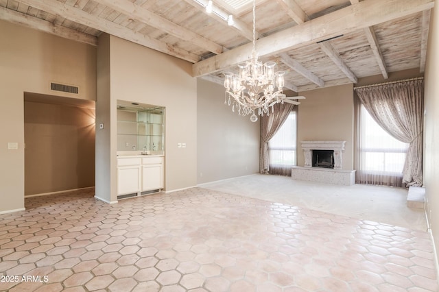 unfurnished living room featuring beam ceiling, sink, wooden ceiling, and a notable chandelier