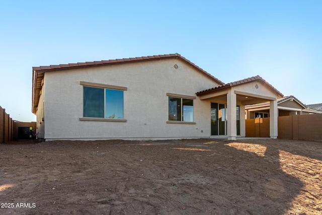 rear view of property featuring central AC