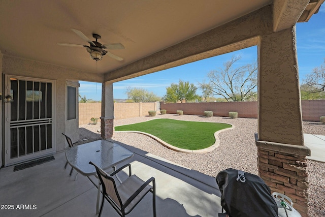 view of patio with a grill and ceiling fan