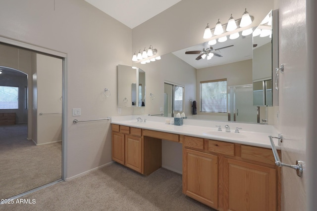 bathroom with vanity, a shower with shower door, lofted ceiling, and ceiling fan