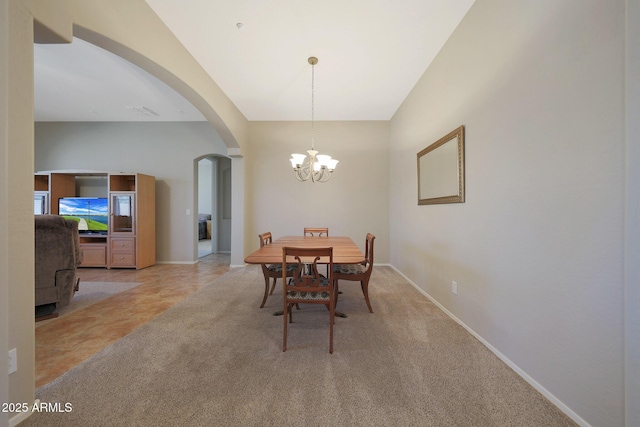 dining area featuring an inviting chandelier and light carpet