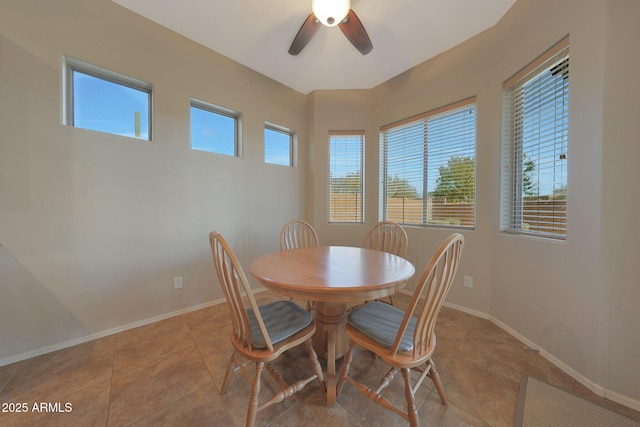 dining space featuring light tile patterned flooring and ceiling fan