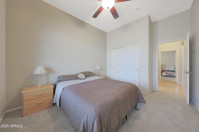 carpeted bedroom featuring lofted ceiling, a closet, and ceiling fan