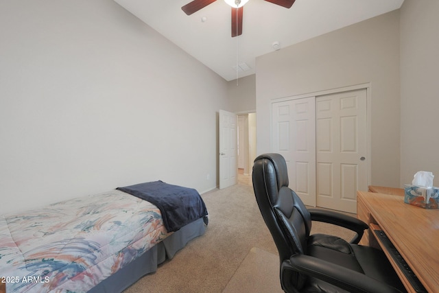 carpeted bedroom with high vaulted ceiling, a closet, and ceiling fan