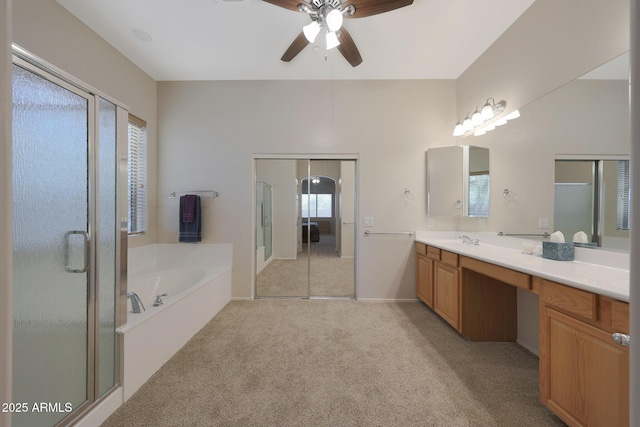 bathroom featuring vanity, ceiling fan, and plus walk in shower