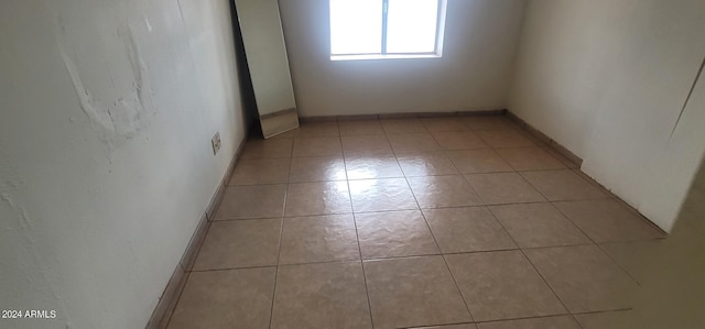 unfurnished room with light tile flooring