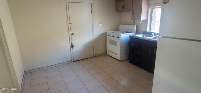 kitchen with white appliances, sink, and light tile floors