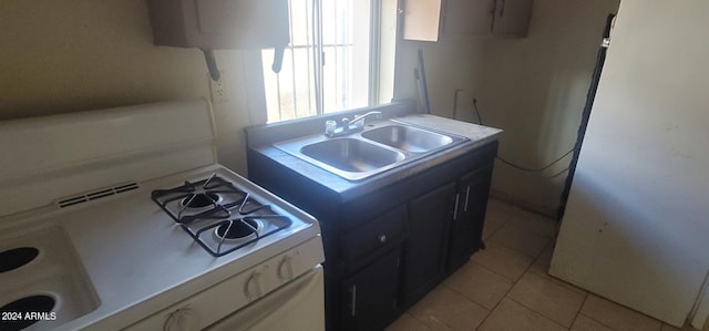 kitchen featuring sink, light tile floors, and range