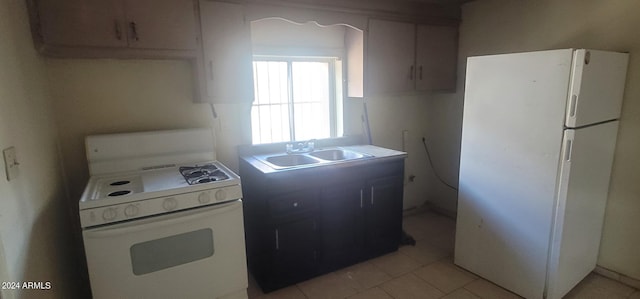 kitchen with sink, white appliances, and light tile floors