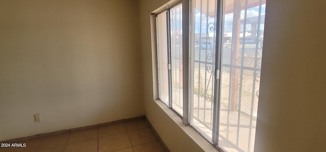 unfurnished room featuring light tile floors