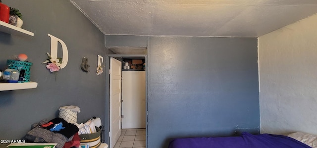 tiled bedroom featuring a textured ceiling