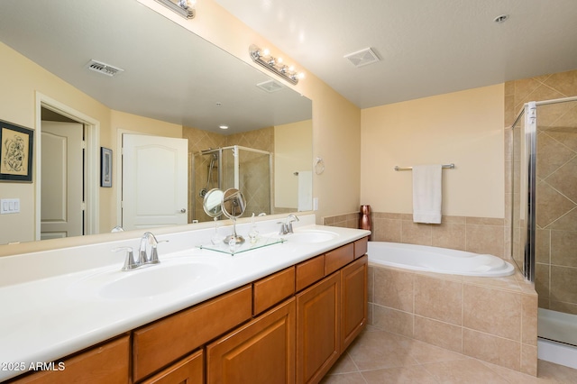 bathroom with independent shower and bath, tile patterned flooring, and vanity