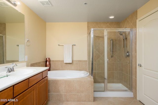 bathroom featuring tile patterned flooring, separate shower and tub, and vanity