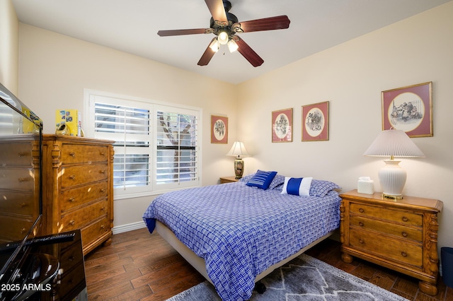 bedroom featuring ceiling fan and dark hardwood / wood-style floors