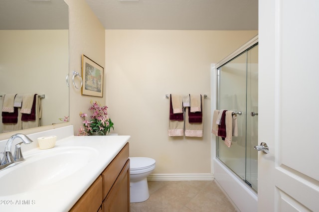 full bathroom with tile patterned floors, bath / shower combo with glass door, vanity, and toilet