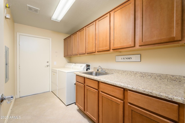 laundry room featuring sink, cabinets, independent washer and dryer, and electric panel