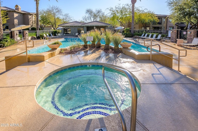 view of pool featuring a hot tub and a patio