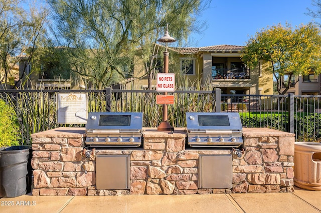 view of patio / terrace featuring an outdoor kitchen and a grill