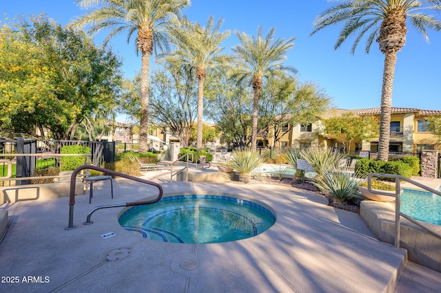 view of swimming pool featuring a community hot tub