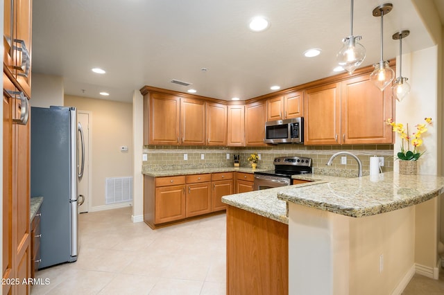 kitchen featuring stainless steel appliances, light stone counters, kitchen peninsula, decorative backsplash, and pendant lighting