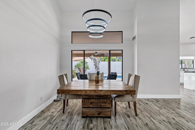 8913 S Forest Ave, Tempe, AZ 85284 - dining space with wood finished floors, baseboards, and a high ceiling