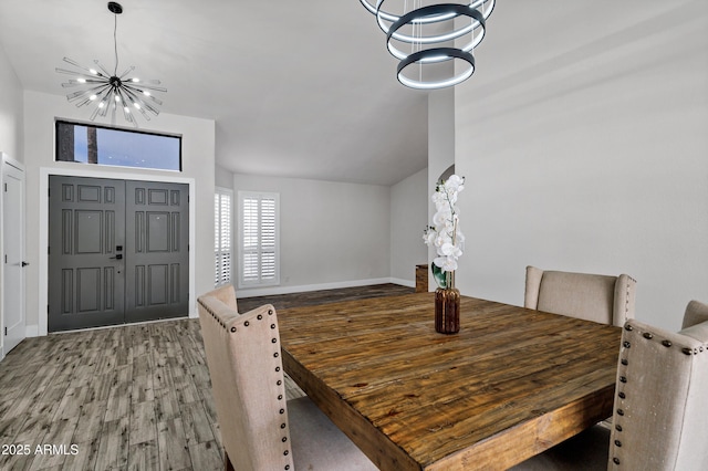 8913 S Forest Ave, Tempe, AZ 85284 - dining area with a chandelier, wood finished floors, baseboards, and vaulted ceiling