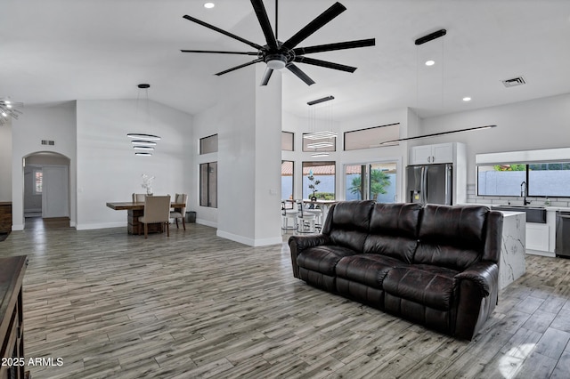 8913 S Forest Ave, Tempe, AZ 85284 - living area featuring ceiling fan, high vaulted ceiling, light wood-style floors, plenty of natural light, and arched walkways