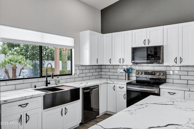 8913 S Forest Ave, Tempe, AZ 85284 - kitchen with appliances with stainless steel finishes, a sink, backsplash, and white cabinetry