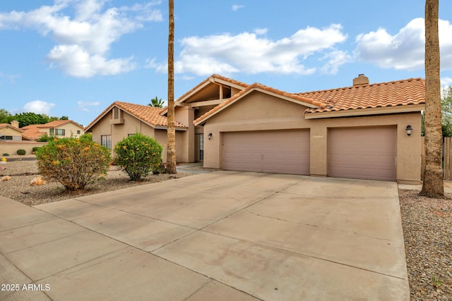 8913 S Forest Ave, Tempe, AZ 85284 - view of front of home with stucco siding, a garage, a tile roof, driveway, and a chimney