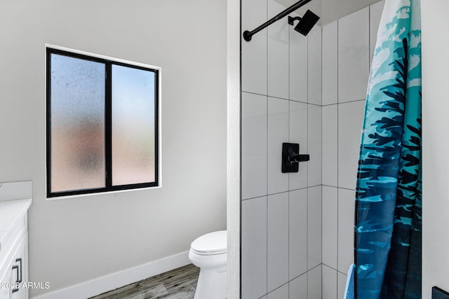 8913 S Forest Ave, Tempe, AZ 85284 - full bathroom with healthy amount of natural light, a tile shower, toilet, and wood finished floors