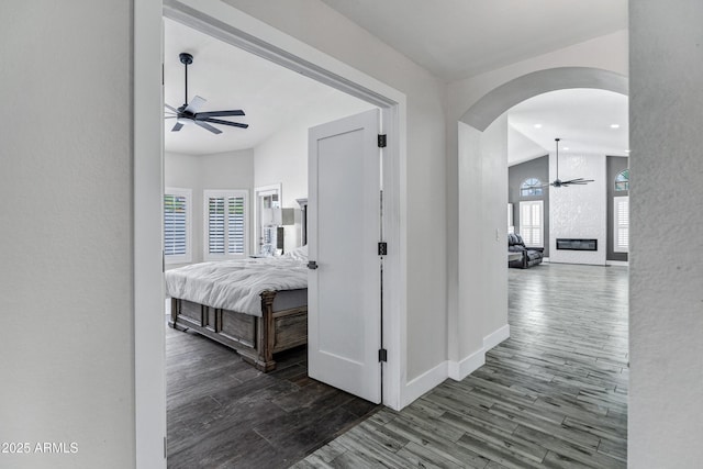 8913 S Forest Ave, Tempe, AZ 85284 - hall featuring arched walkways, wood finished floors, healthy amount of natural light, baseboards, and recessed lighting