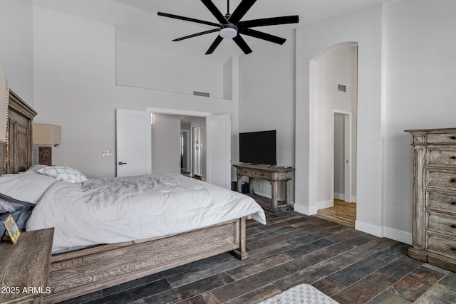 8913 S Forest Ave, Tempe, AZ 85284 - bedroom with high vaulted ceiling, arched walkways, baseboards, and a ceiling fan