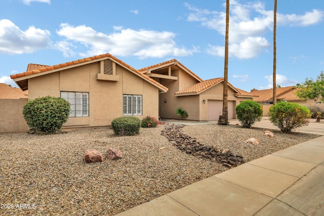 8913 S Forest Ave, Tempe, AZ 85284 - view of front of house featuring stucco siding, an attached garage, and a tiled roof