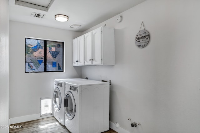 8913 S Forest Ave, Tempe, AZ 85284 - laundry area with baseboards, cabinet space, light wood-style flooring, and separate washer and dryer