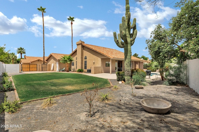 8913 S Forest Ave, Tempe, AZ 85284 - rear view of house featuring a tile roof, stucco siding, a chimney, and a patio area