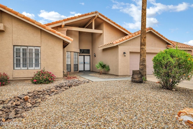 8913 S Forest Ave, Tempe, AZ 85284 - view of front of house featuring an attached garage, stucco siding, and a tiled roof