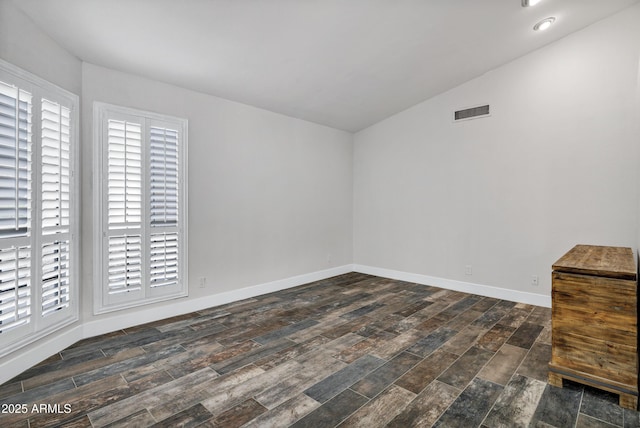 8913 S Forest Ave, Tempe, AZ 85284 - unfurnished room featuring vaulted ceiling, dark wood-type flooring, plenty of natural light, and baseboards