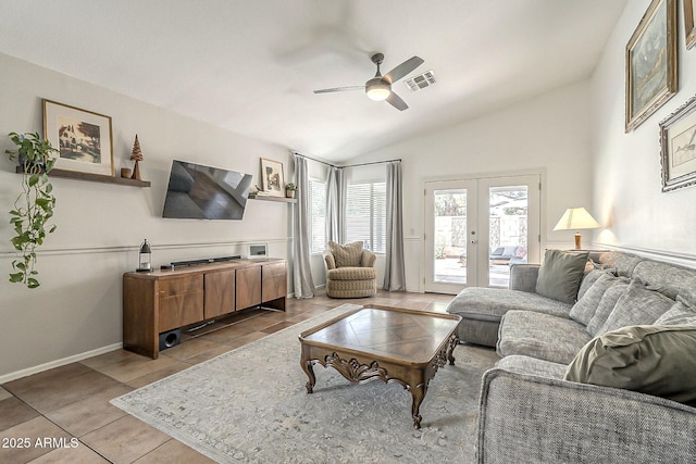 tiled living area with vaulted ceiling, visible vents, a ceiling fan, french doors, and baseboards