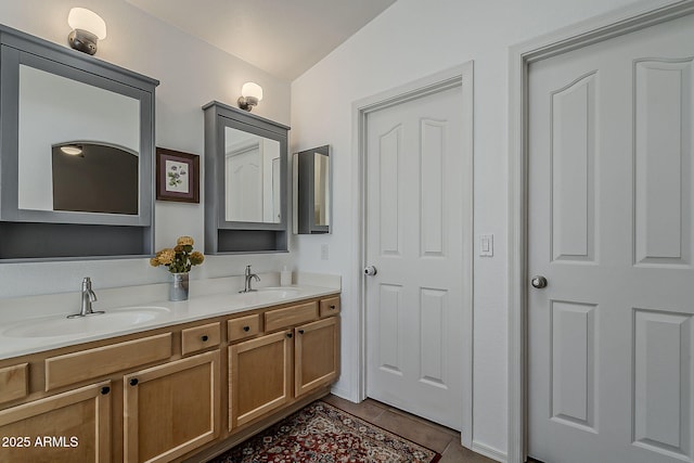 full bath featuring tile patterned floors, a sink, and double vanity